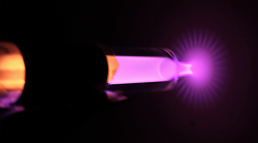 Helium atmospheric pressure plasma jet blooming towards the surface of a thick glass-ceramic block