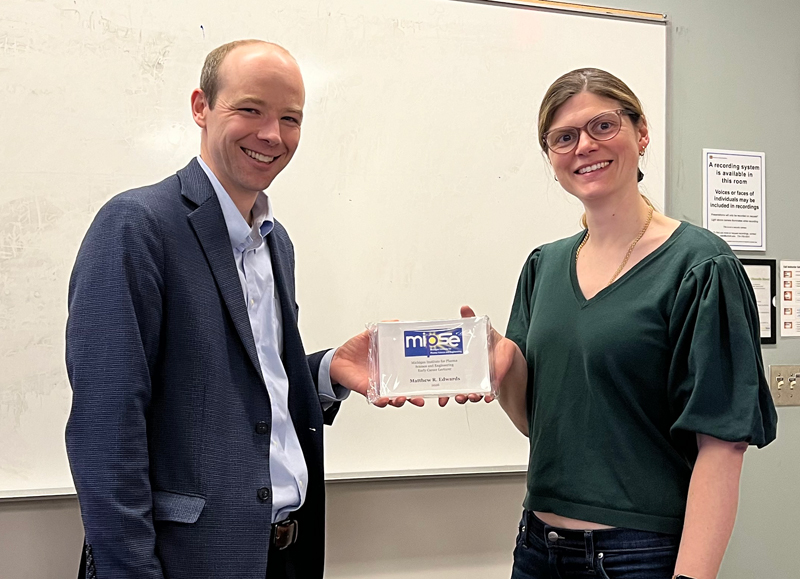 Matthew Edwards receives his plaque from Louise Willingale